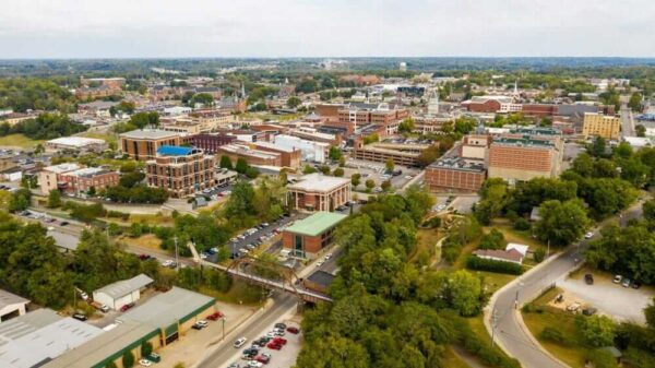 Aerial view of downtown urban landscape featuring historic buildings and greenery.