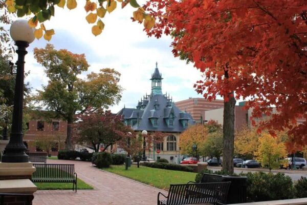 Charming Victorian building amid vibrant fall foliage in historic downtown Columbus.