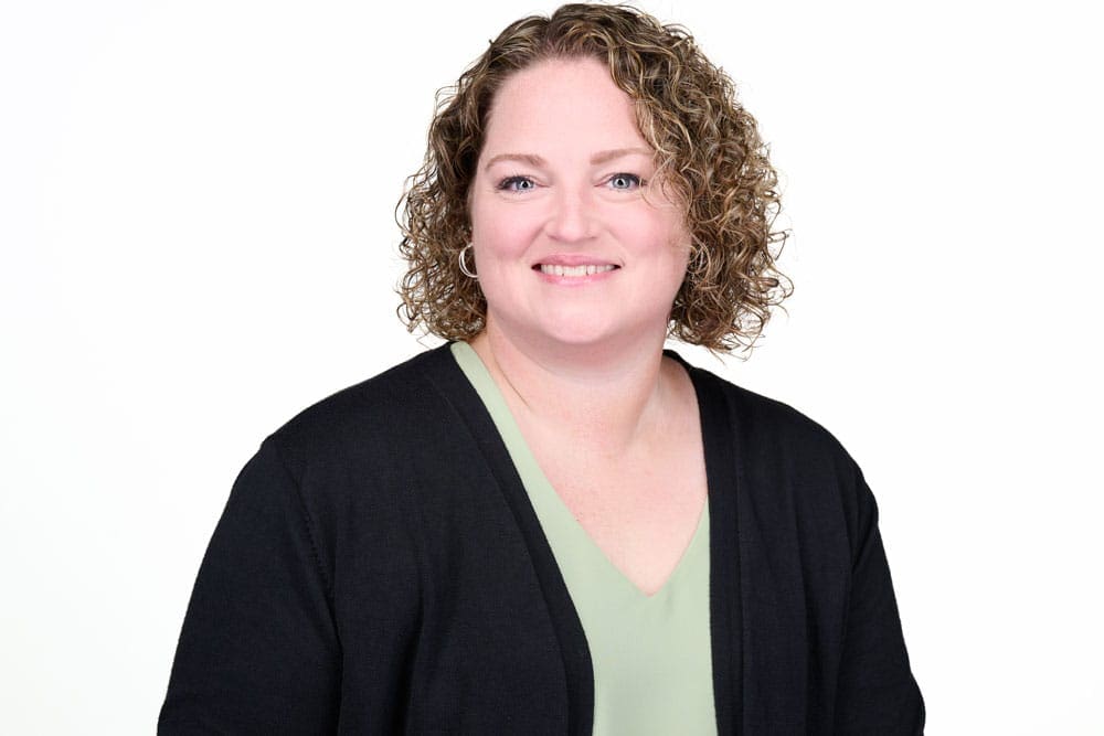 Professional headshot of woman on white background.