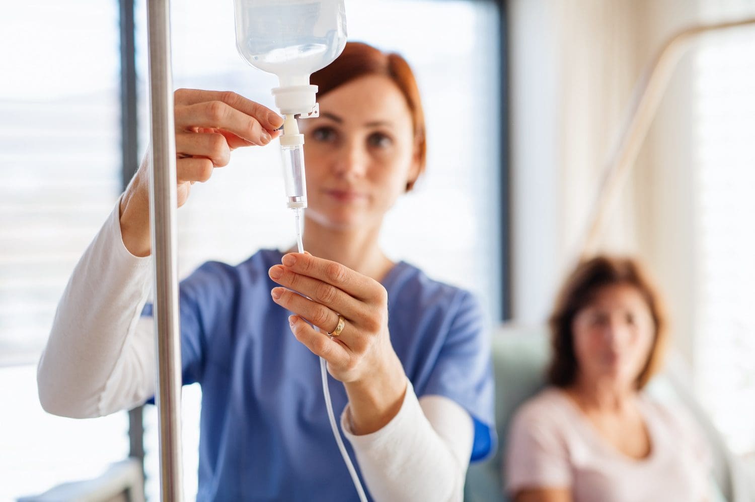 Nurse adjusting IV drip for patient care. Optimal health services at [Brand Name].